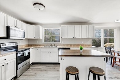Kitchen with stainless steel appliances, white cab
