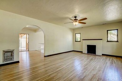 Alternate view of living room with arched entrance
