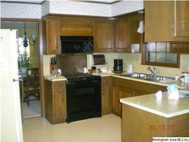 Kitchen has lots of cabinets, pantry, laundry clos