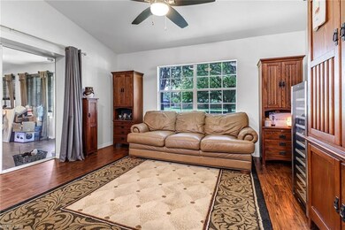 Sitting room off of the kitchen with dark hardwood