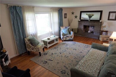 The bright, sizable living room with rich hardwood