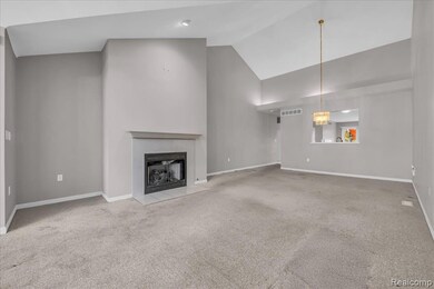 Unfurnished living room with light carpet, a fireplace, and high vaulted ceiling