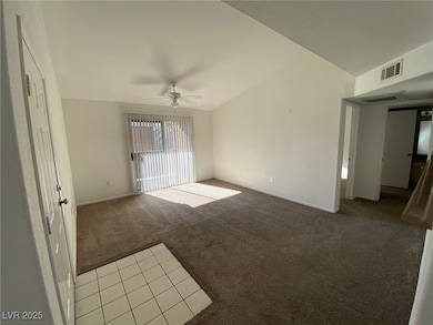 Spare room featuring light colored carpet and a ce