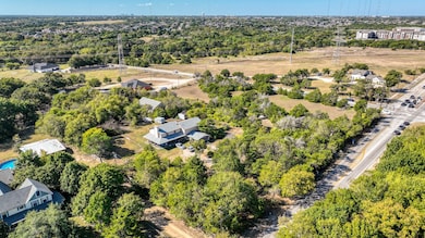 Aerial overview of property's location with a tree filled landscape