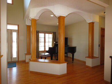 Versatile dining room area with arches and wood pi