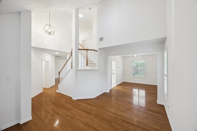 The living room opens to the dining room which overlooks the backyard. Notice the updated light fixtures