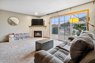 Open and bright living room with corner gas fireplace and large sliding doors to the deck.