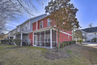Back of property with a sunroom and a lawn