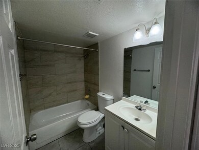 Bathroom with a textured ceiling,  shower combinat