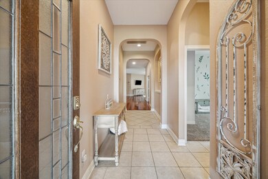 This warm entryway with tile floor welcomes you in