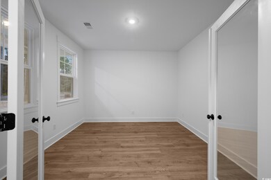 Empty room featuring visible vents, baseboards, fr