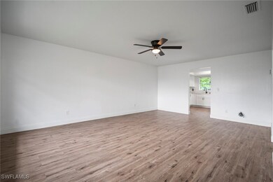 Unfurnished room with wood finished floors and cei