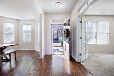 Entrance foyer featuring baseboards and dark wood finished floors