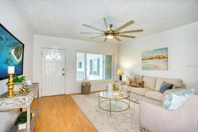 Spacious living room with wood laminate floor & ne