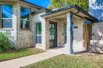 View of exterior entry featuring brick siding