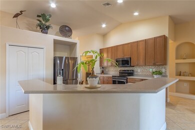 Kitchen featuring visible vents, light countertops