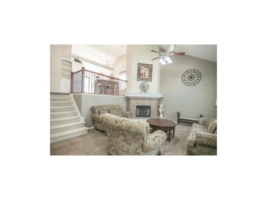 Great room with gas fireplace and soaring ceiling 