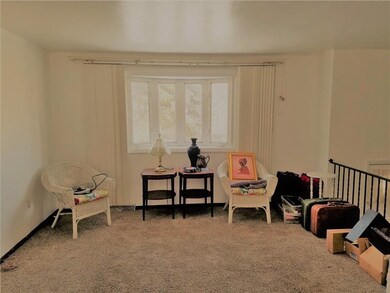 Living room has bright bay windows.