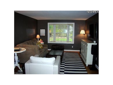 Living room with bay window and wood flooring