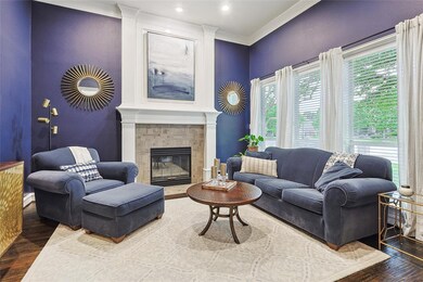 Living room with ornamental molding and dark hardwood / wood- floors and gas fireplace. This could also serve as a study.