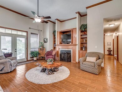 Living room featuring ceiling fan, a tile fireplac