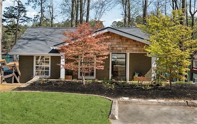 View of front facade with a shingled roof and a fr