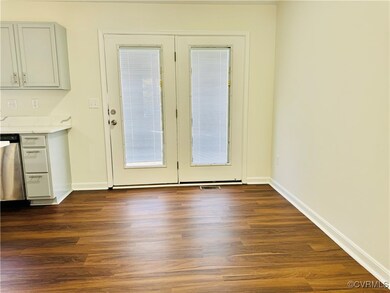 Doorway to outside featuring dark hardwood / wood-