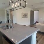 Kitchen featuring an island with sink, wood finish