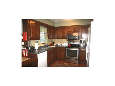 KITCHEN WITH WOOD FLOORING AND STAINLESS OVEN/MICR