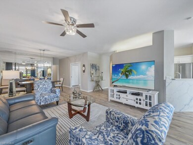 Living area with baseboards, a ceiling fan, and li