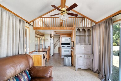 Living room with vaulted ceiling, ceiling fan, lig