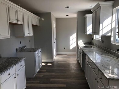 Kitchen with custom cabinets and granite counterto