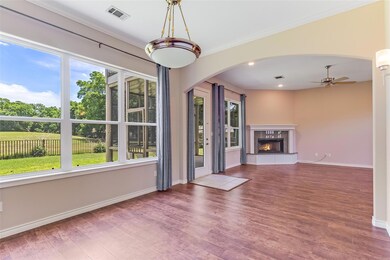 Unfurnished living room featuring arched walkways