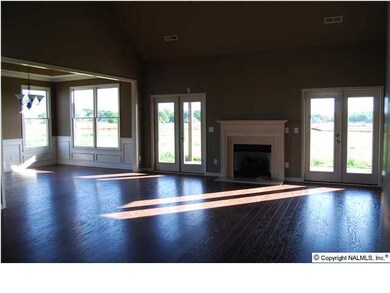 Large family room with gas fire, double patio doors to the back porch and yard. Cathedral ceiling. Very open.