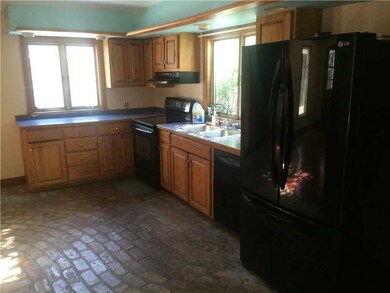 Kitchen. Brick flooring wraps around to fireplace