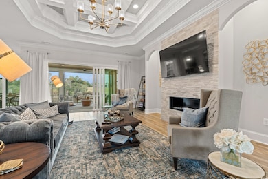 Living room featuring coffered ceiling, hardwood /