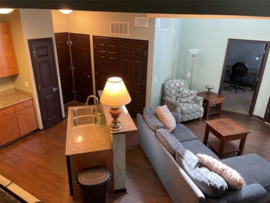 Living room with dark wood-style floors and a desk
