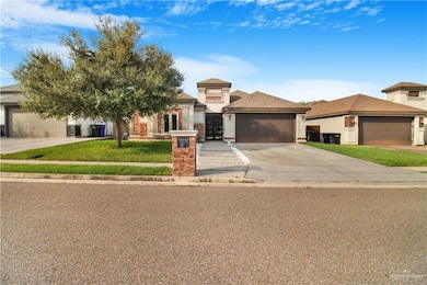 Prairie-style home featuring a front yard and a garage