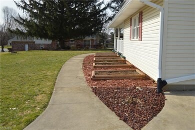 Individual flower beds along front walk leading to
