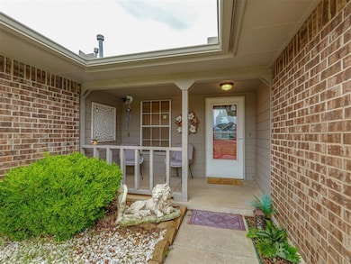 View of exterior entry featuring covered porch and