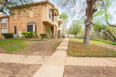 View of home's exterior featuring a balcony, brick