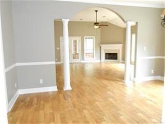 Archway, columns,, warm fireplace, and nice french