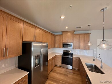 Kitchen featuring hanging light fixtures, applianc