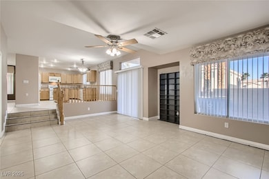 Empty room with visible vents, ceiling fan, basebo