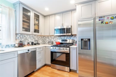 Kitchen with light countertops, backsplash, and stainless steel appliances