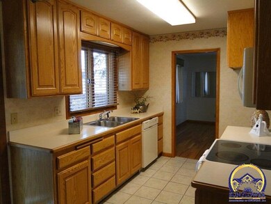 This wonderful kitchen offers ceramic tile floors and Custom Wood Cabinetry