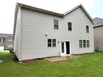 Rear view of property with a lawn