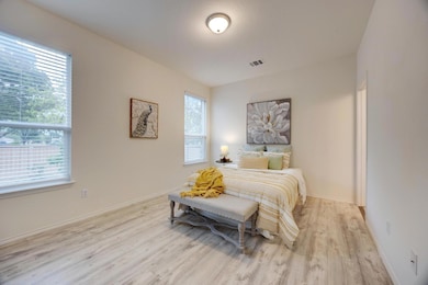 Bedroom featuring baseboards, wood finished floor