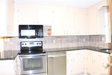 Kitchen with granite countertops, stainless applia
