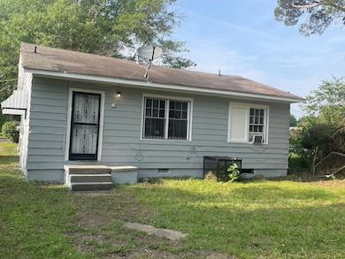 Rear view of property with a lawn, cooling unit, a